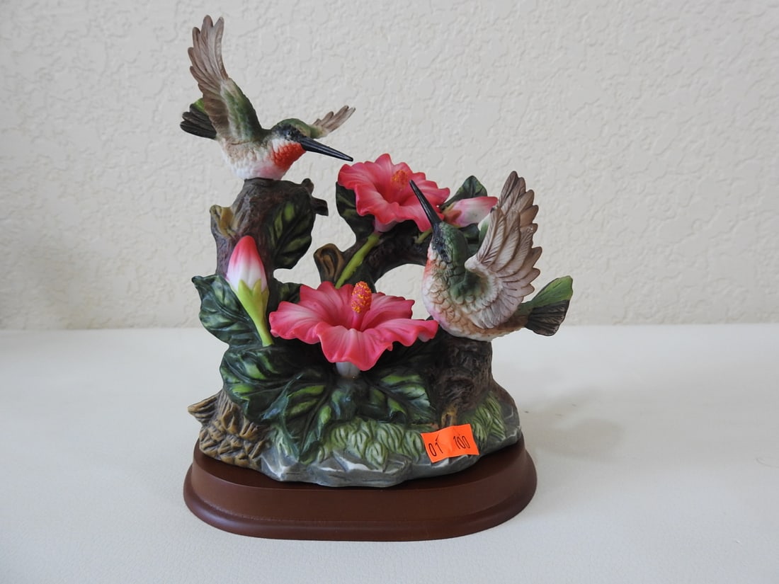 Vintage Porcelain Hummingbirds with Hibiscus Figurine: Vintage porcelain hummingbirds with hibiscus floral base, made in China. Approx. 7 x 5.75 x 4.25 in.