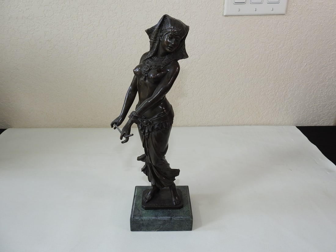 Bronze Nefertiti Statue on Green Marble Base: Bronze Nefertiti statue on dark green marble base, signed/noted Marloton. Approx. 13.75 x 4.25 x 3.5 in.