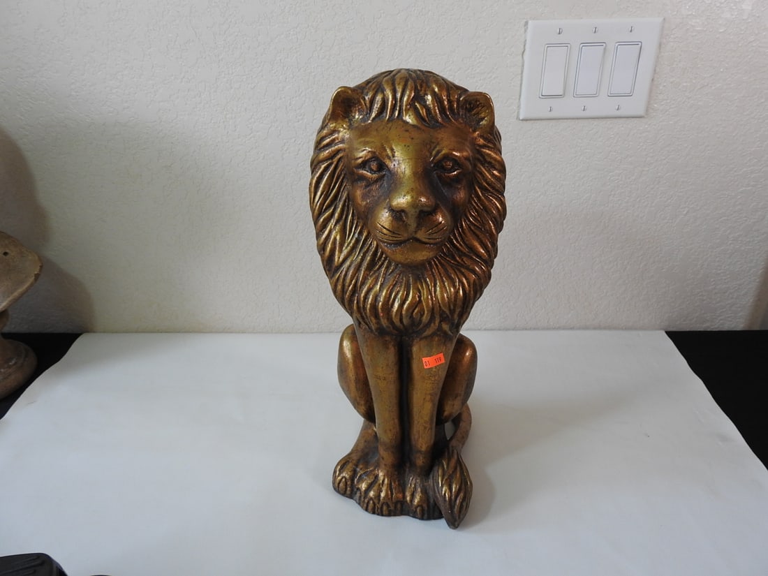 Gold Gilt Plaster Lion Statue: Gold gilt plaster lion statue with seated pose. Approx. 17 x 7.5 x 9.25 in.