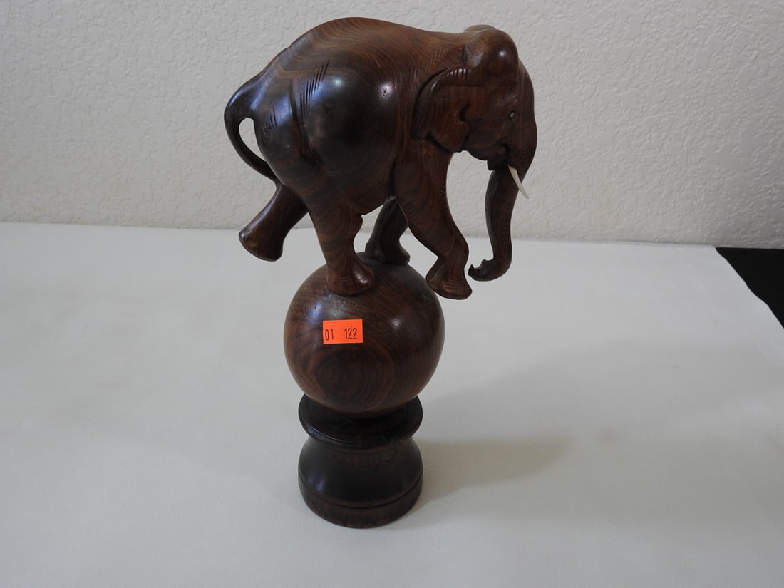 Carved Circus Elephant Figure: Carved circus elephant figure with inlaid ivory/bone-style eyes and tusks on pedestal base. Approx. 10.75 x 3.5 x 5.75 in.