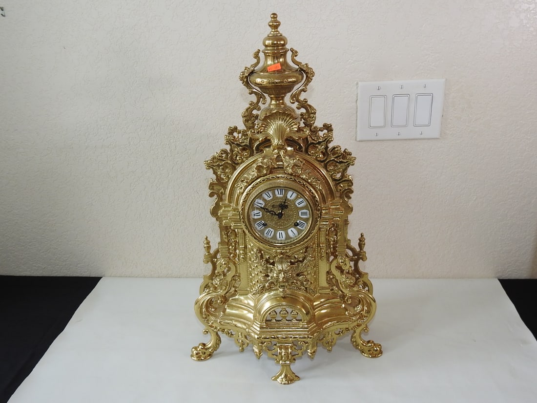 Vintage Baroque Style G&G Solid Brass Mantel Clock: Vintage Baroque style solid brass mantel clock by G&G with applied Bacchus / God of Wine cast decoration and original winding key. Approx. 25 x 13.5 x 6.5 in.