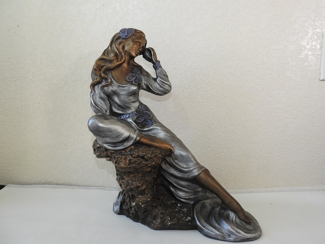 Alice Heath “Sea Whispers?? Faux Bronze Statue: Faux bronze “Sea Whispers” statue signed Alice Heath. Minor chips to bottom area and paint chipping noted; see photos. Approx. 19 x 16 x 12 in.