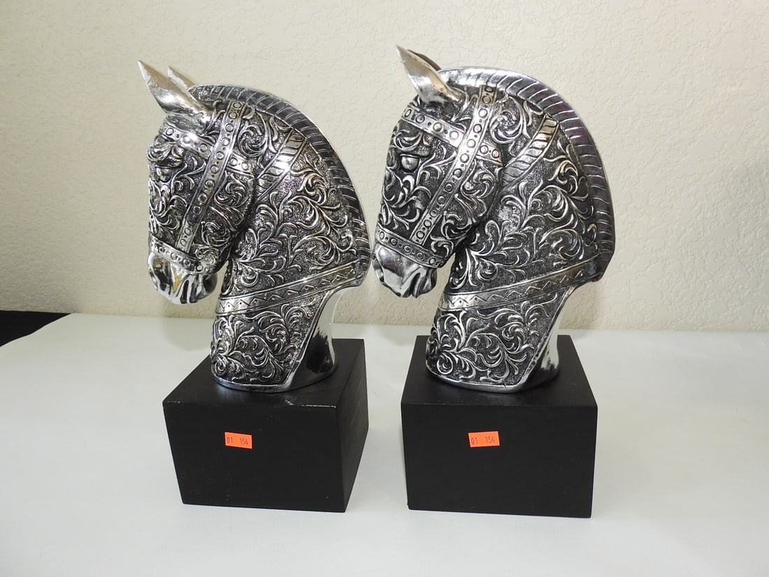 Pair of Silver Tone Horse Busts: Pair of hollow aluminum horse busts with silver tone coating. Approx. 12.75 x 9 x 5 in.