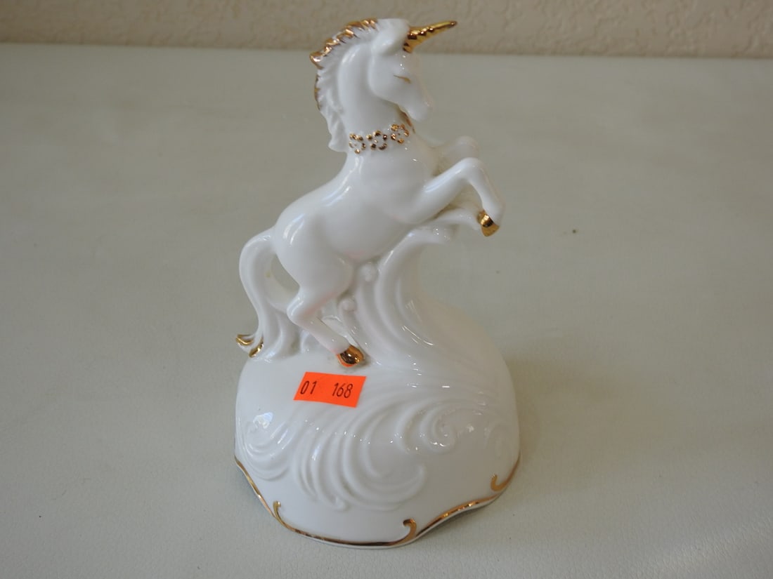 Vintage Enesco “Fascination?? Porcelain Unicorn Music Box: Vintage Enesco porcelain unicorn music box titled “Fascination,” dated 1981, with 24K gold accents. Tested working. Approx. 6 x 4 x 4 in.