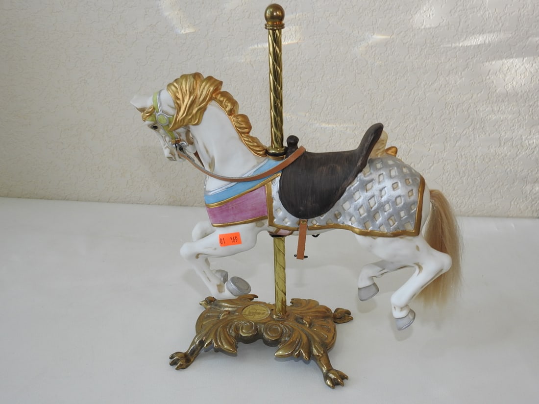 Tobin Fraley Porcelain Carousel Horse, 2nd Edition: Porcelain standing carousel horse by American carousel artist Tobin Fraley, 2nd Edition #335 of 9500, with brass pole and porcelain horse base. Approx. 12.75 x 11 x 4.75 in.
