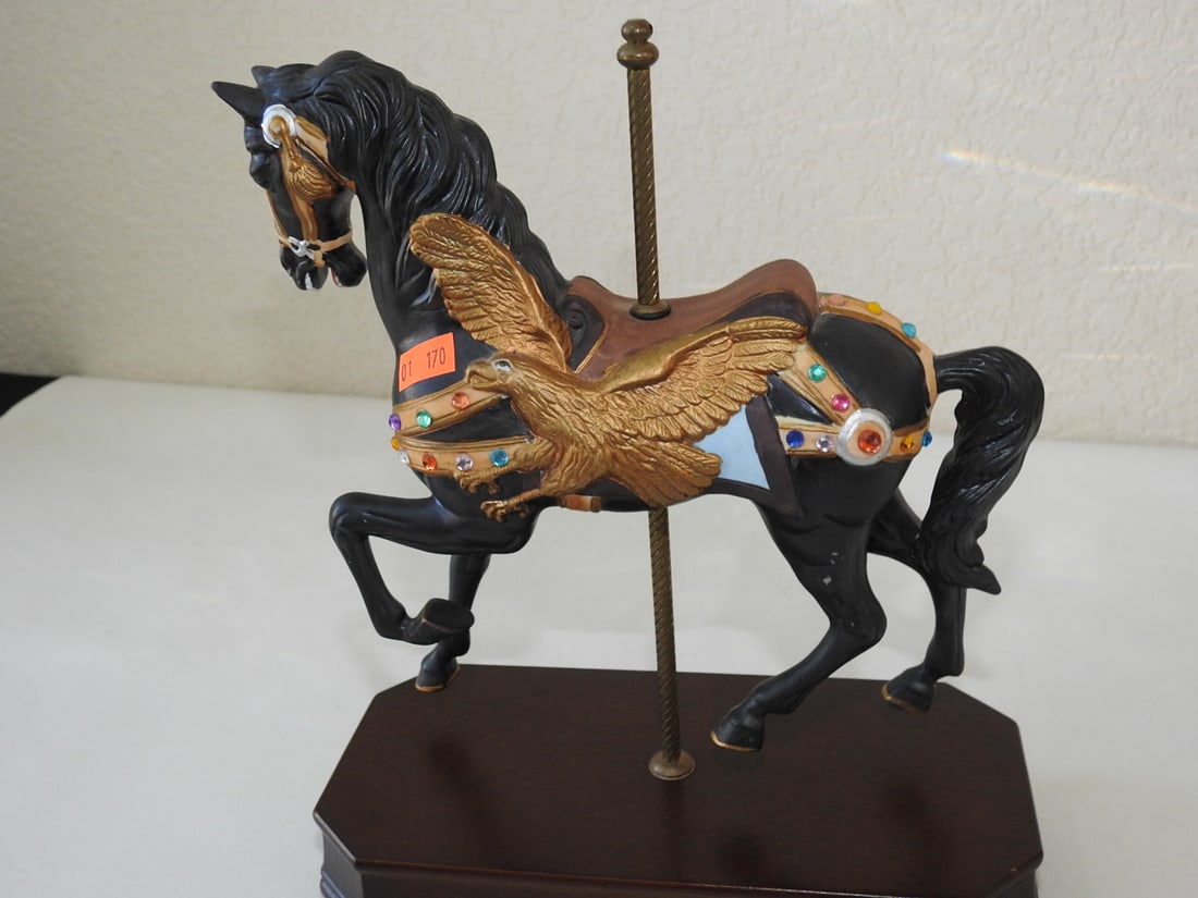 Black Porcelain Carousel Horse Music Box: Black hand-painted porcelain carousel horse music box with jewel accents, wooden base, and solid brass pole. Tested working. Approx. 11 x 9 x 4.25 in.