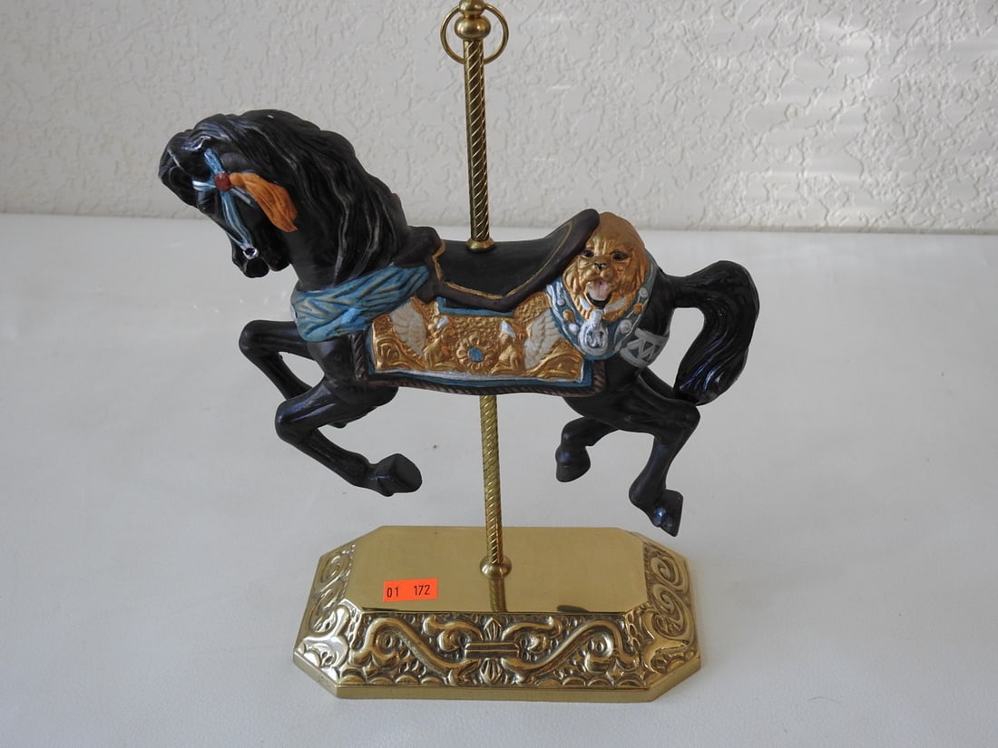Black Porcelain Carousel Horse with Brass Base: Hand-painted black porcelain carousel horse with brass base, brass pole, and gold accents. Approx. 9.5 x 8 x 3.75 in.