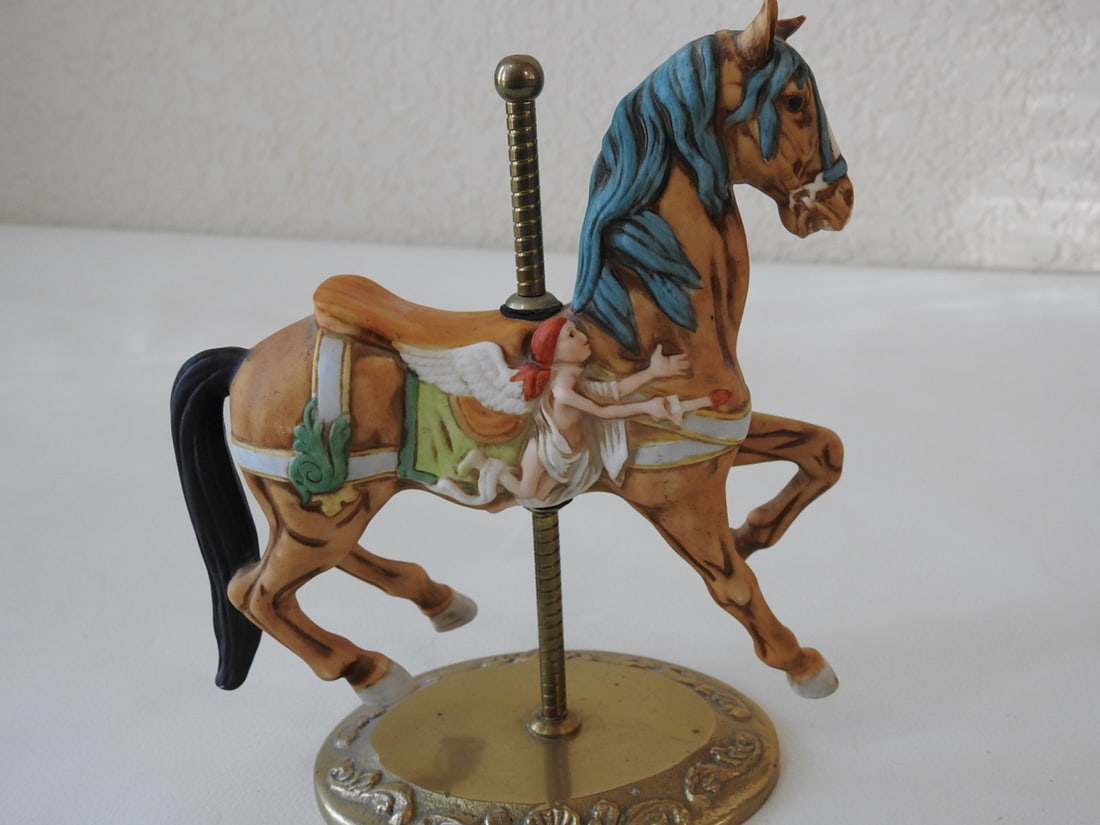 Hand-Painted Bisque Porcelain Carousel Horse: Hand-painted bisque porcelain standing carousel horse with brass base and pole. Approx. 7.25 x 6.5 x 3.25 in.