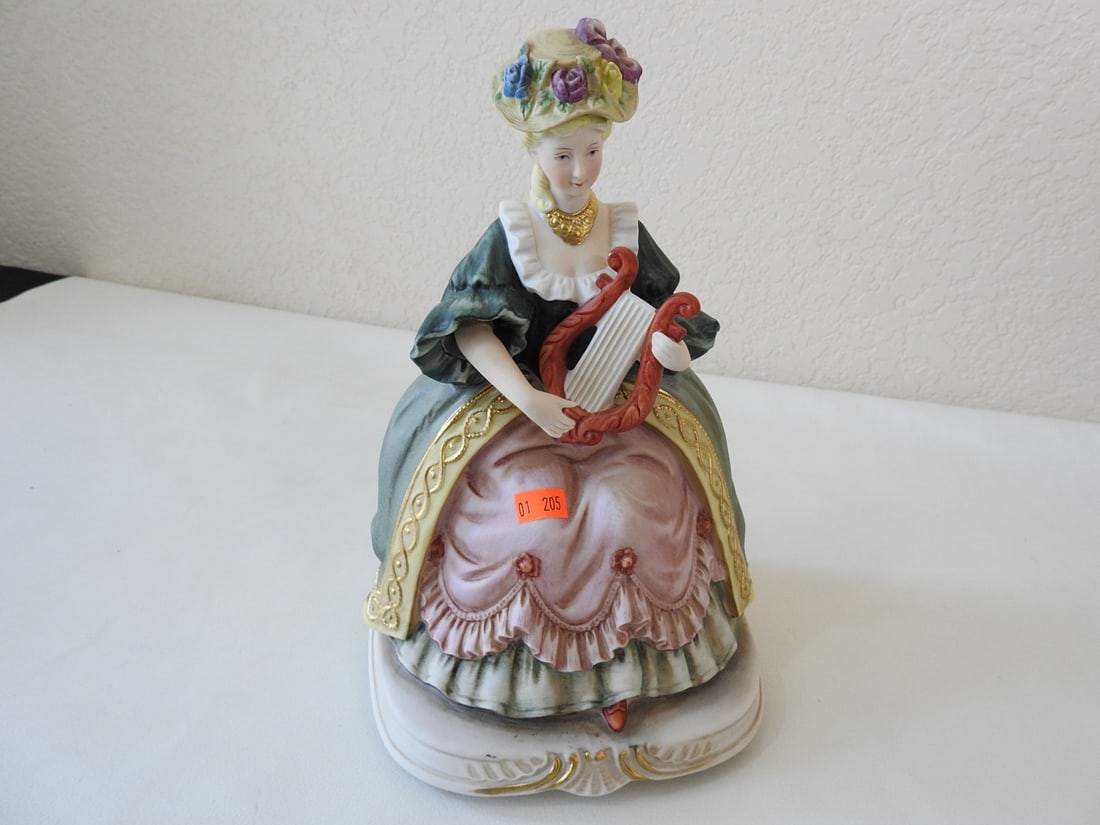 Vintage French Aristocrat Porcelain Music Box: Vintage French aristocrat porcelain music box with gold gilt necklace. Battery pack corrosion present from batteries left inside; figurine itself is in good condition. Approx. 11 x 6.5 x 6.5 in.