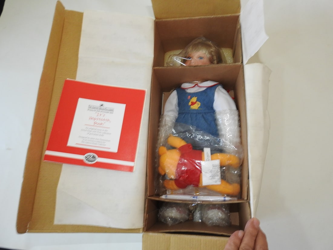 Ashton-Drake “It’s Hopscotch Pooh?? Doll: Ashton-Drake Galleries “It’s Hopscotch Pooh” doll, complete set with certificate of authenticity. Approx. 15 x 6.5 x 5 in.