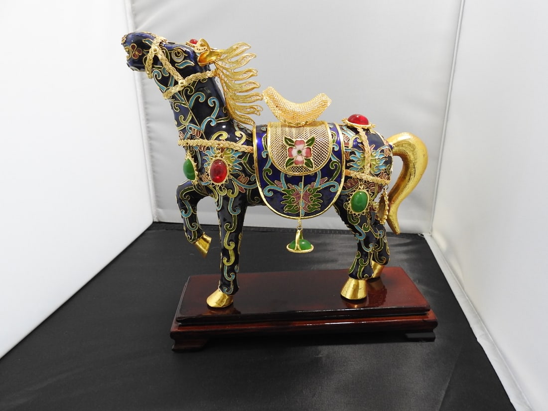 Vintage Cloisonne Tang Dynasty Royal Horse Statue: Vintage cloisonne Tang Dynasty royal horse statue with jeweled and filigree decoration, gold plated finish, glass jewels, and footed wooden base. Approx. 10.25 x 10 x 3.25 in.