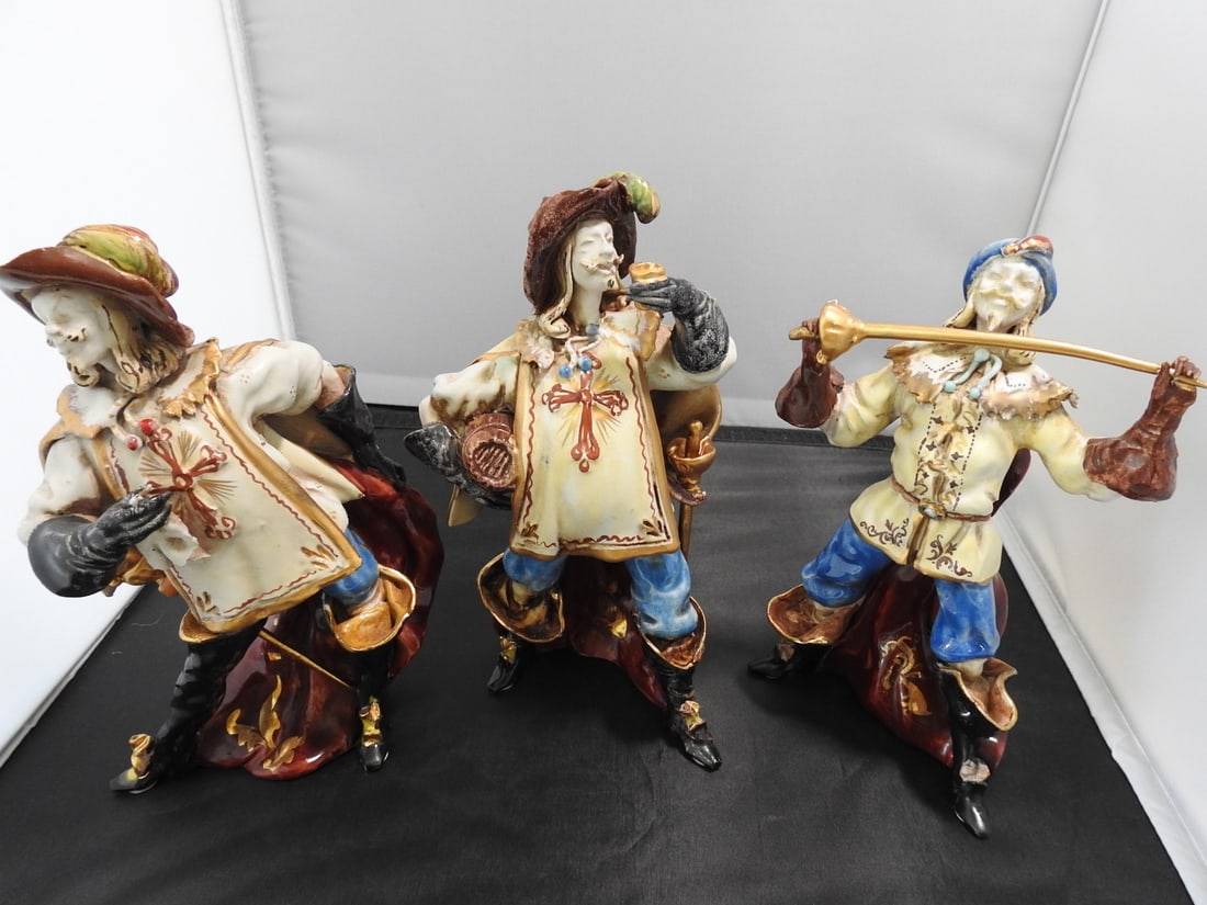 Gio Italy Three Musketeers Figurines Set: Gio Italy mid-century Three Musketeers figurines set, model #9056, hand-formed, glazed, and hand-painted with gold gilt accents. Approx. 8 x 8 x 6 in.
