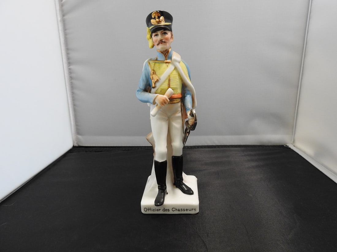 Bone White China Napoleonic Wars Soldier Figure: Bone white china soldier figure marked “French Napoleonic Wars Officier des Chasseurs, ” hand-painted with gold and silver gilt. Approx. 8 x 2.5 x 3 in.