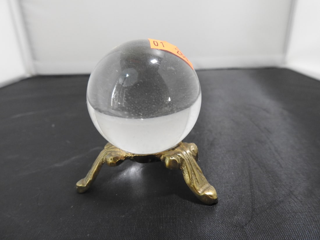 Natural Crystal Quartz Sphere on Brass Stand: Natural Crystal Quartz sphere, Sits on a 3 footed brass base Approx. 2.5 x 3 x 3 in.