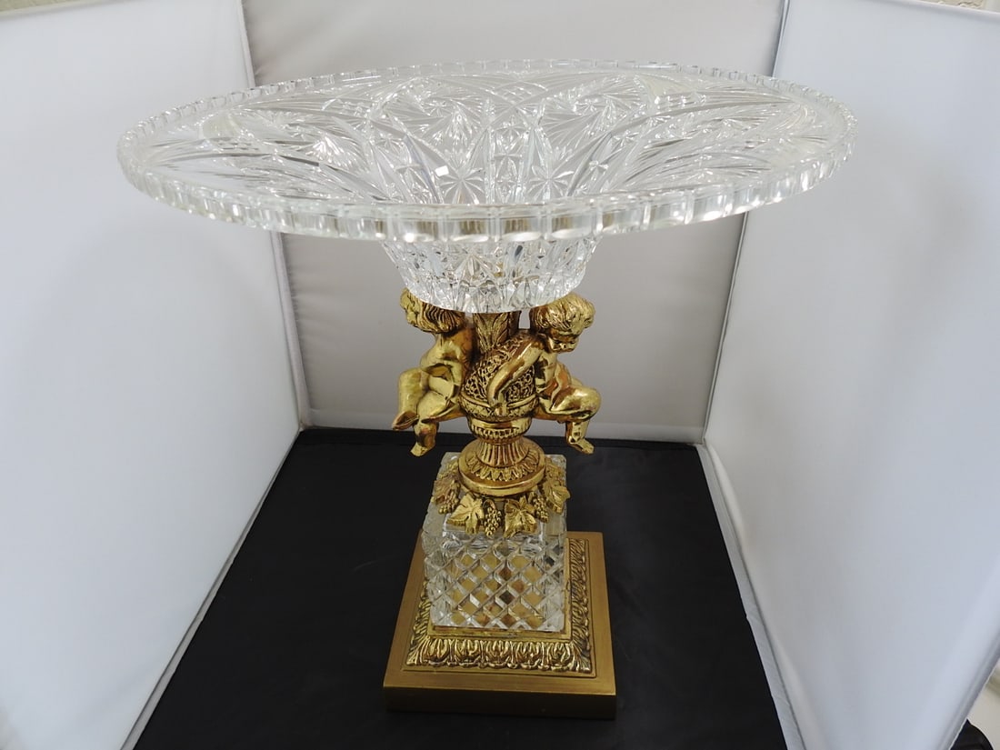 Large Crystal and Brass Pedestal Centerpiece: Large Crystal and Brass Pedestal Centerpiece. With Cupid Made in Germany 24% Lead Crystal Approx. 15 x 13 x 13 in.