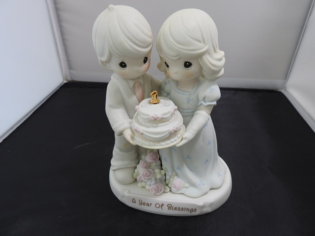 Precious Moments Porcelain Figurine: Precious Moments Porcelain Figurine. "A year of Blessings" Serial # 163783 By Enesco Copyrighted 1995 Approx. 7 x 5.5 x 3.5 in.