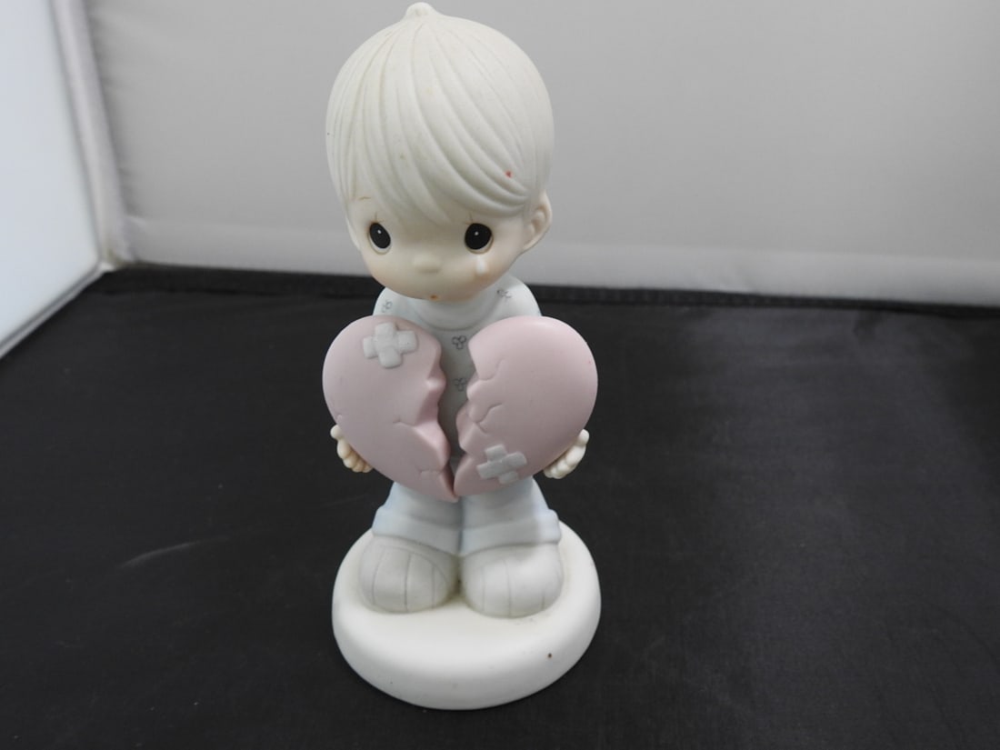 Precious Moments Porcelain Figurine: Precious Moments Porcelain Figurine. "This too shall pass" Serial # 114014 By Enesco Copyrighted 1987 - Samuel J. Butcher Approx. 6 x 3 x 2.5 in.