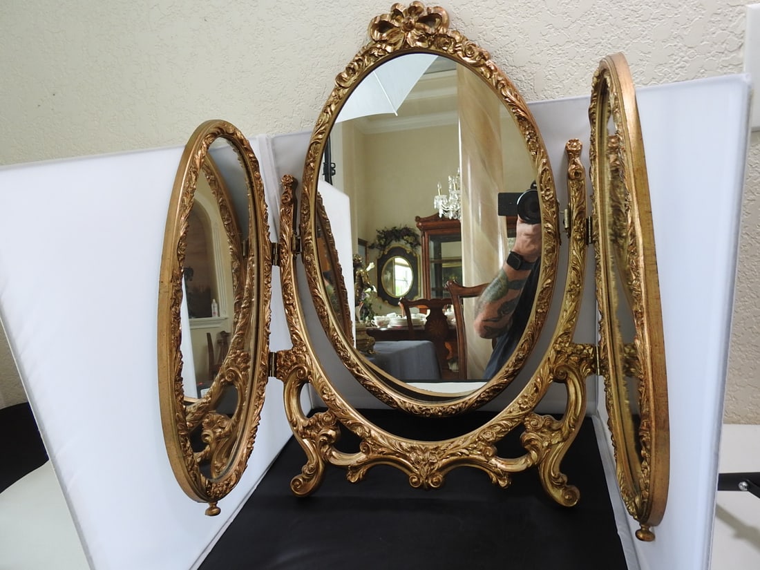 Vintage Antiqued Gold Tri-Fold Mirror: Vintage Antiqued Gold Tri-Fold Mirror. Cast metal, Tilting, classic old-world style, green felted back, Approx. 23.5 x 15.5 x 3 in.