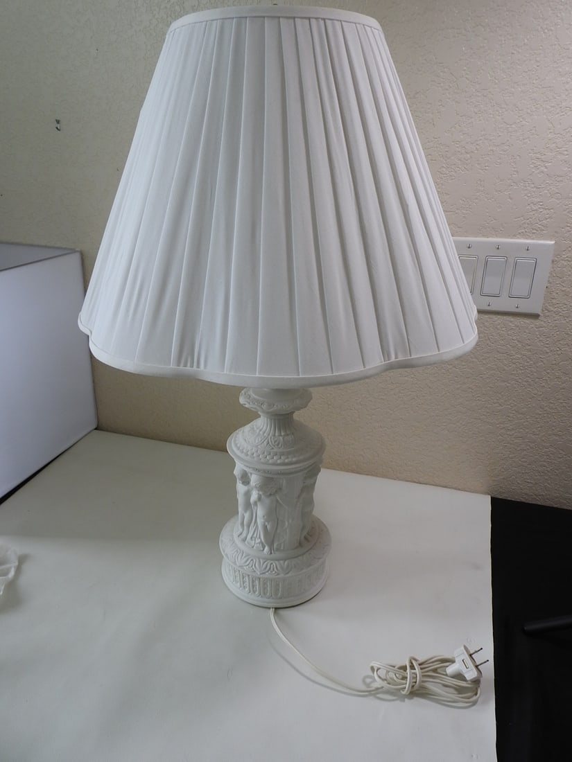 Classical style white bisque porcelain lamp: Classical style white bisque porcelain lamp. White relief design, by Dresden Approx. 29 x 19 x 19 in.