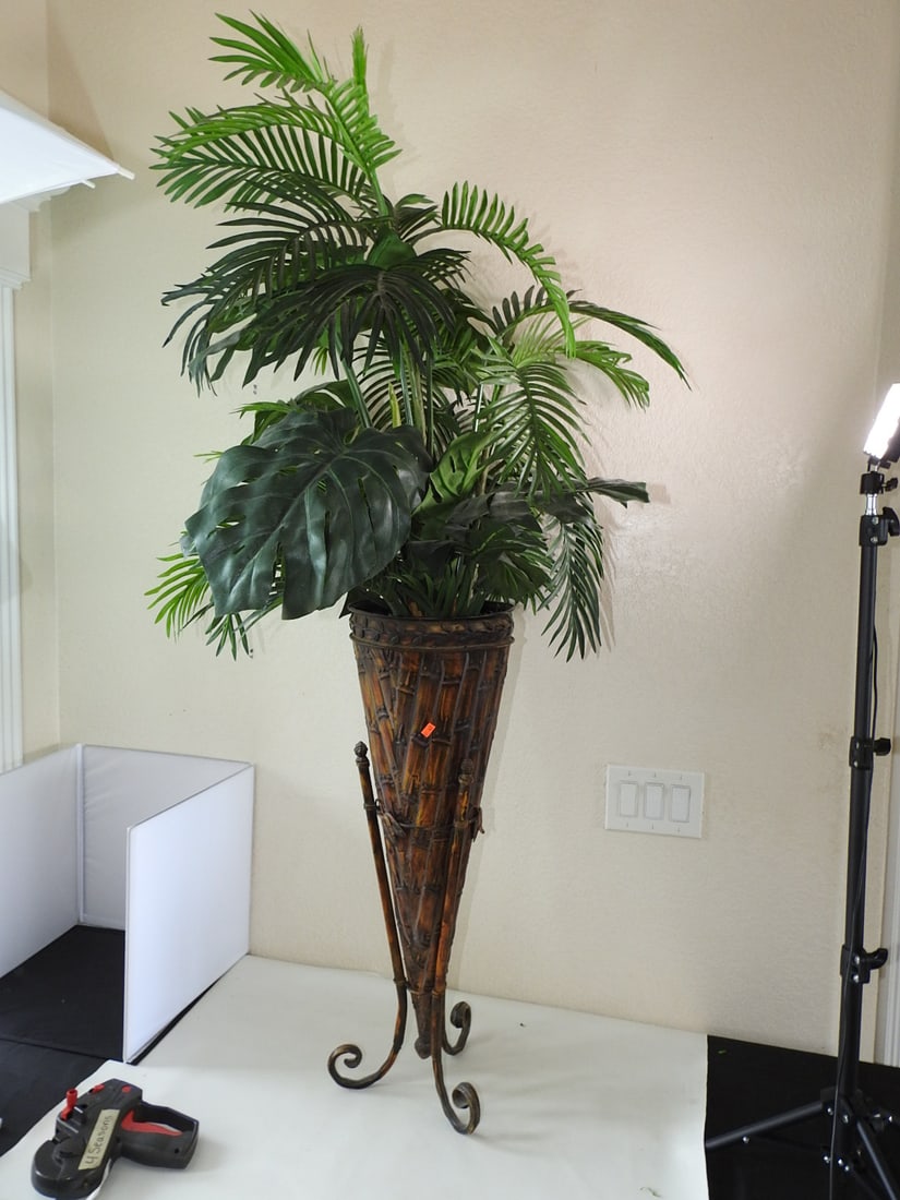 Faux Palm Tree in Footed Horn-Style Base: Faux Palm Tree in Footed Horn-Style Base. Faux bamboo Painted metal Approx. 60 x 27 x 27 in.