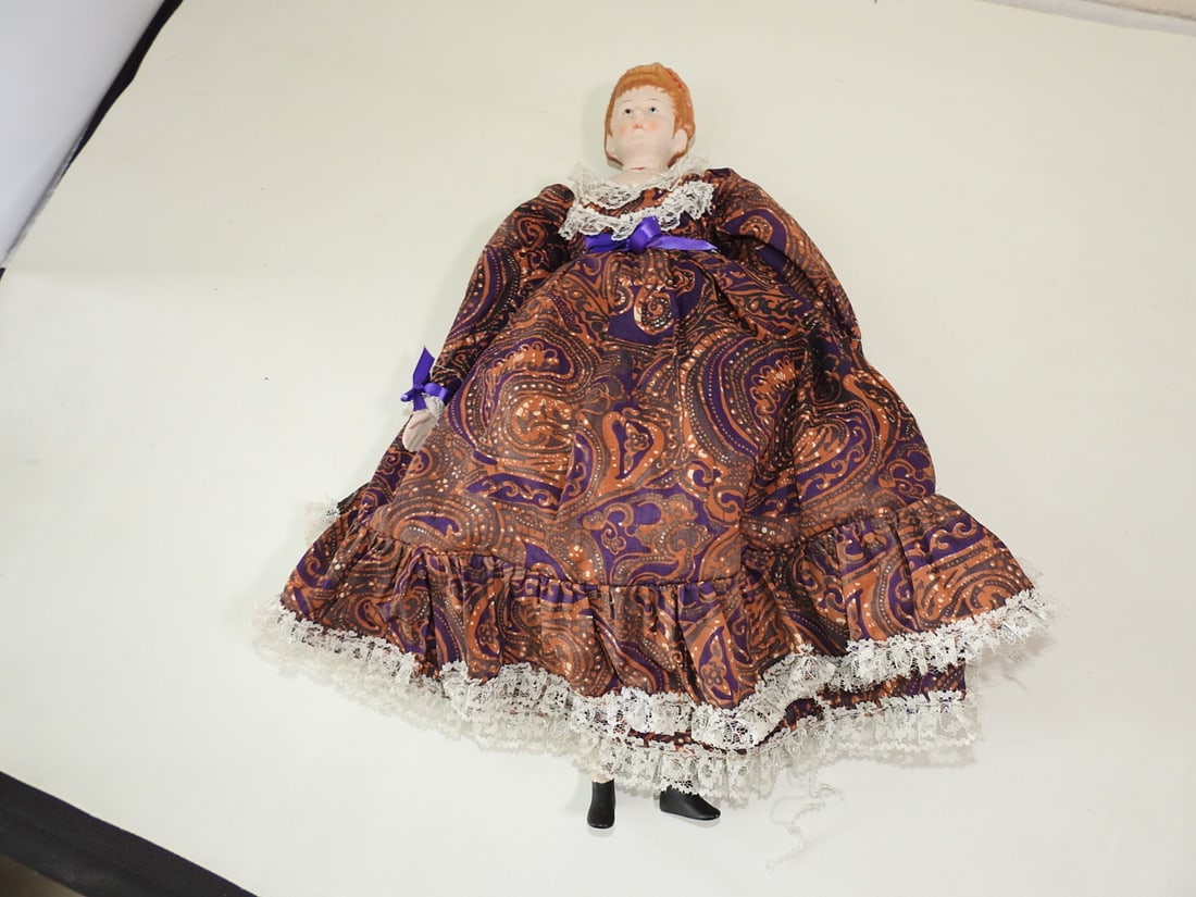 Victorian Style Porcelain Doll: Victorian Style Porcelain Doll. Clothes are attached and will not come off, Few minor tears to the edge of the lace, a part on the ruffle was never sewn together, See photos Approx. 19 x 9 x 3.5 in.