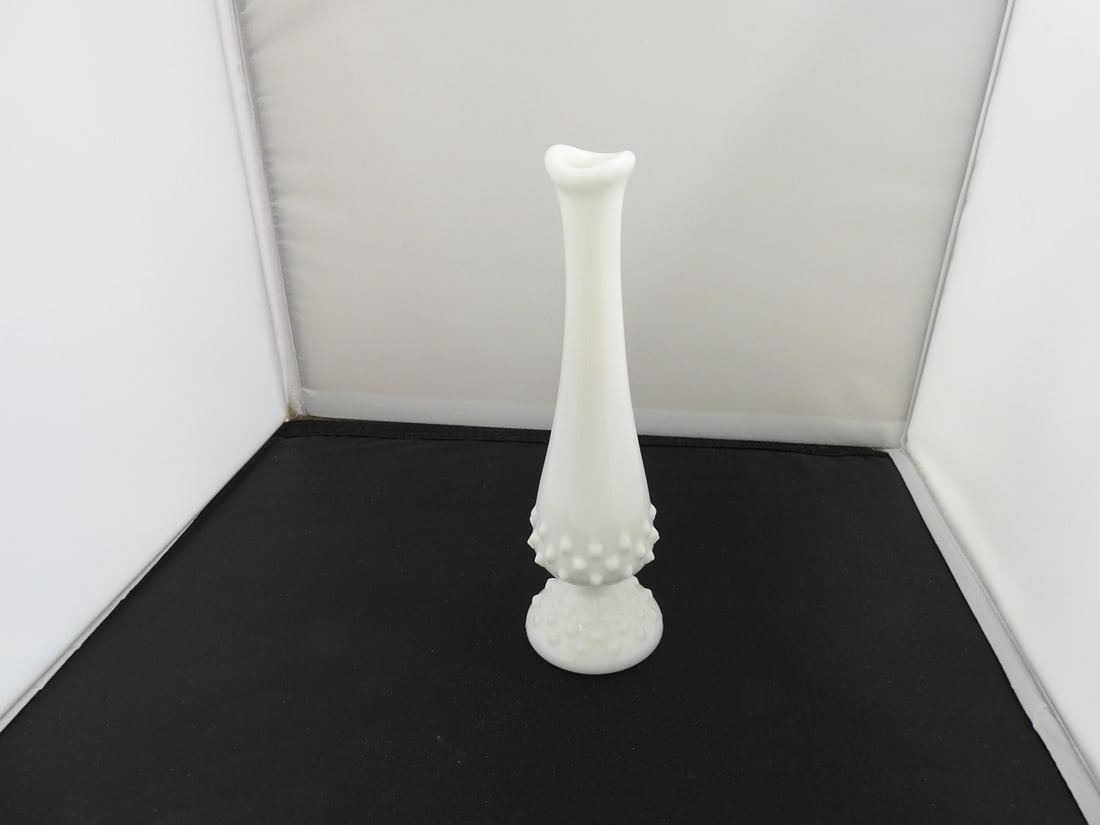 Vintage Milk Glass Hobnail Bud Vase: Vintage milk glass bud vase with slender trumpet form, round pedestal foot, and hobnail decoration near the base. Approx. 8.5 x 2.75 x 2.75 in.