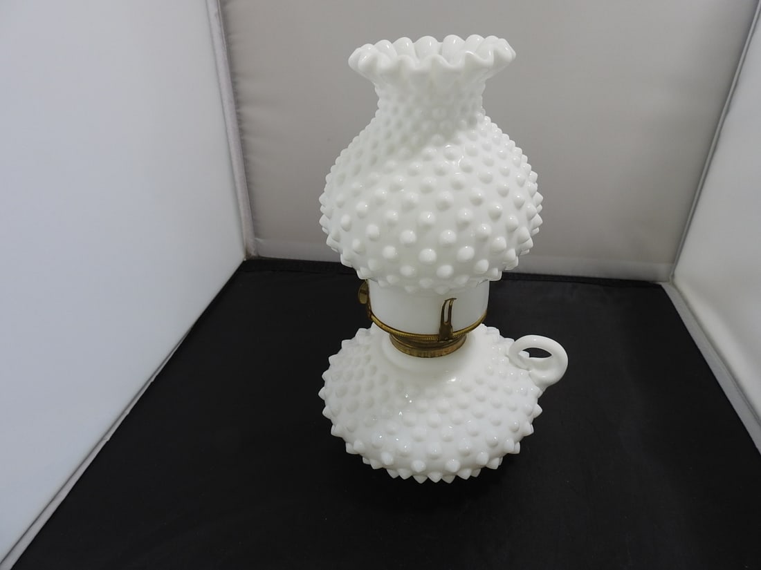 Fenton Milk Glass Hobnail Hurricane Oil Lamp: Vintage Fenton milk glass hurricane oil lamp with hobnail font, ruffled rim shade, brass-tone burner, and clear glass chimney. Approx. 9.5 x 6.5 x 6.5 in.