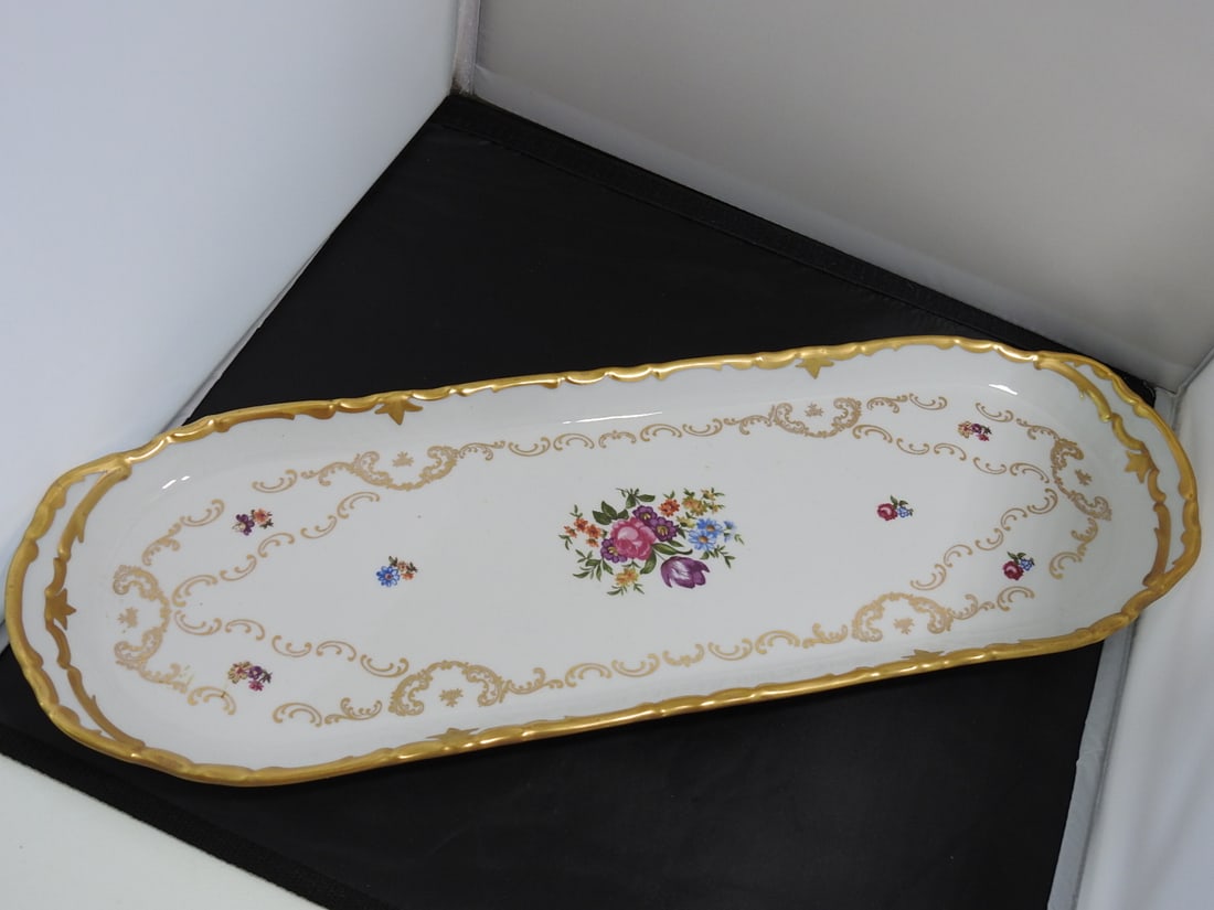 Reichenbach GDR Porcelain Oval Serving Tray: Reichenbach Germany oval porcelain serving tray with floral transfers, shaped rim, and gold gilt accents. Marked German Democratic Republic / GDR. Approx. 20.5 x 7.25 x 1.25 in.