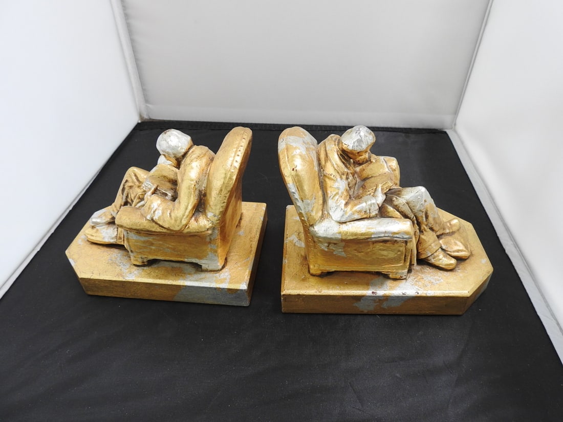 Pair of Gold and Silver Leaf Figural Bookends: Pair of solid plaster figural bookends with gold and silver leaf finish. Noted as John Ruhl / J.B. Hirsch style. Approx. 5.25 x 8.5 x 7 in.