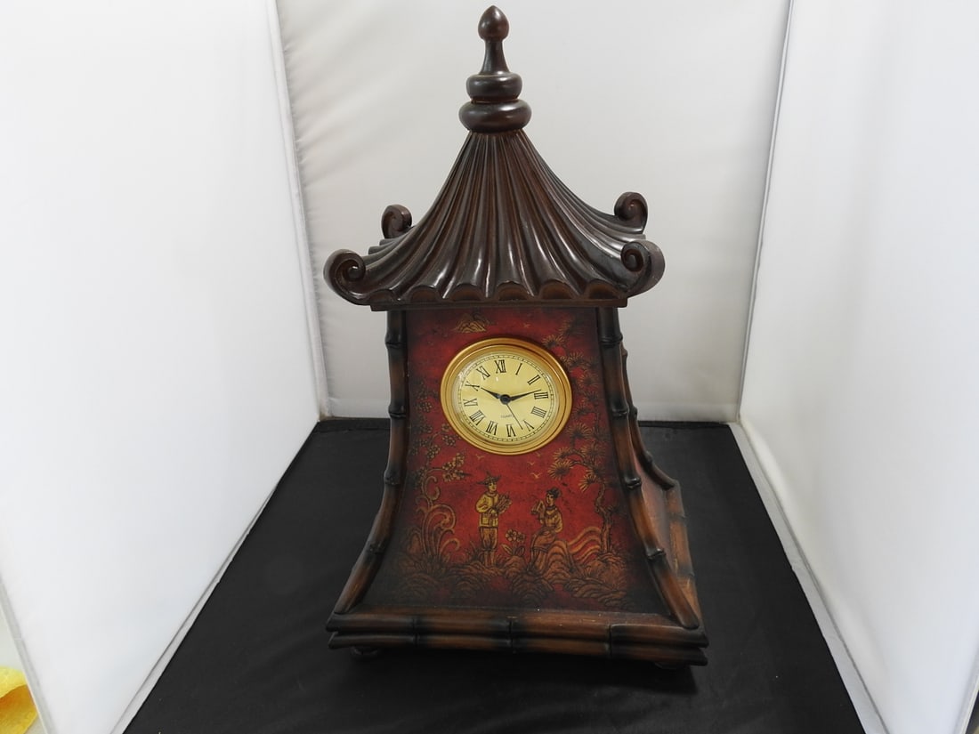 Faux Chinoiserie Pagoda Mantel Clock: Decorative Chinoiserie pagoda style mantel clock with faux wood finish, thick resin body, clock face, and four-footed base. Approx. 14.5 x 9.25 x 6.5 in.