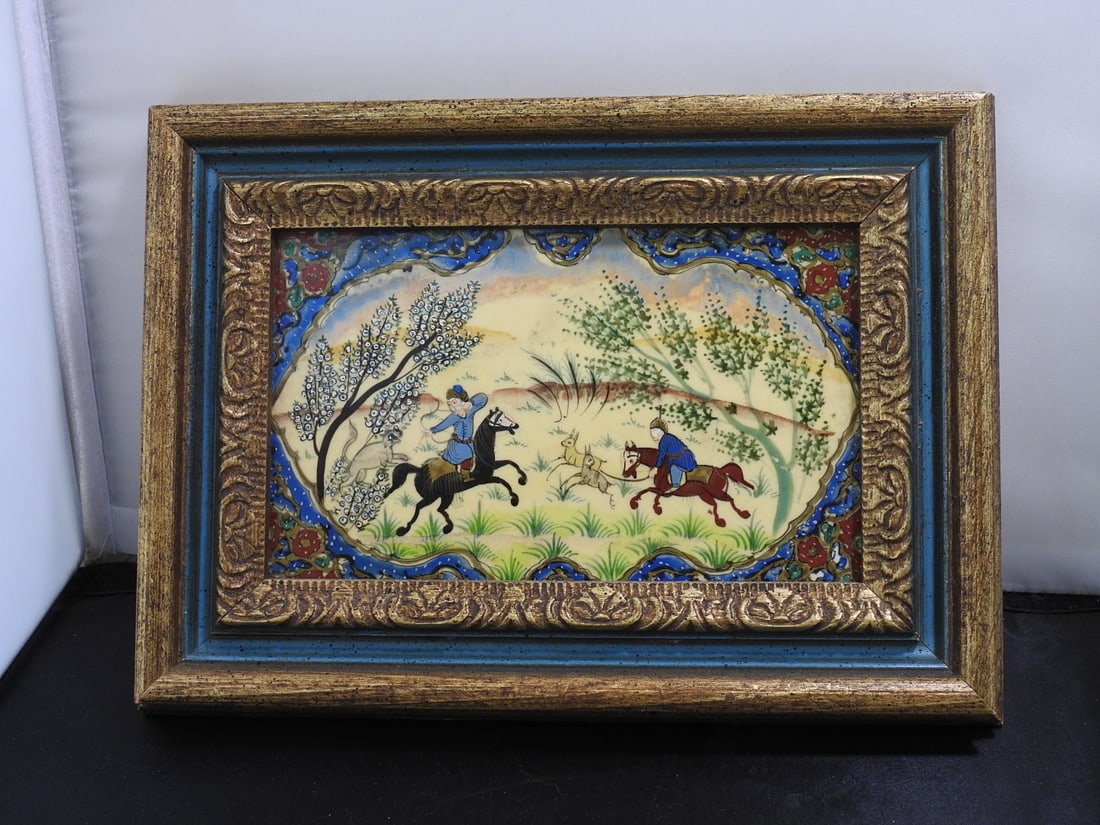 Hand-Painted Persian Bone Composition Framed Picture: Hand-painted Persian style framed picture on bone composition panel in wooden frame, depicting a hunting scene. Back inscription notes hand painted Persian on bone composition. Approx. 8.25 x 11.25 x