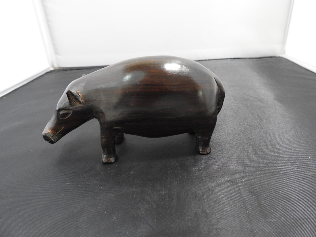 Hand-Carved Exotic Wood Hippopotamus Figure: Hand-carved exotic wood hippopotamus figure with dark polished finish. One ear is broken as noted. Approx. 2.75 x 5.25 x 2 in.