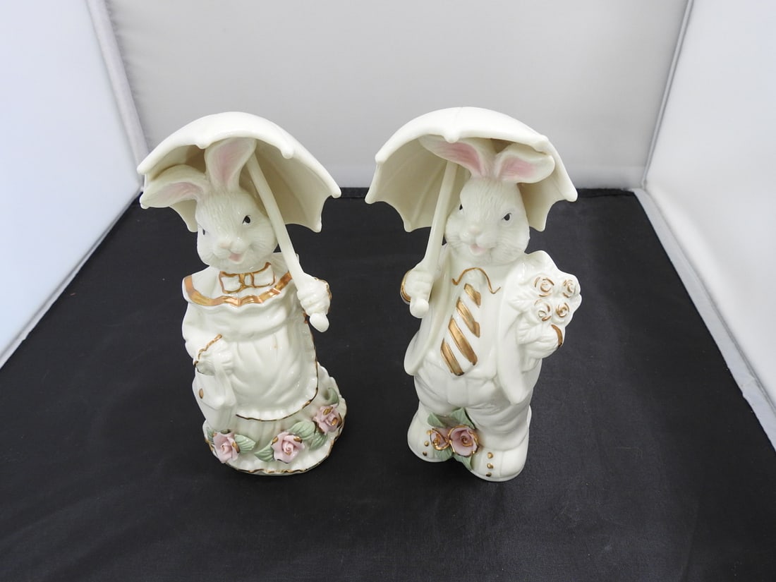 K's Collection Mr. and Mrs. Bunny Ceramic Figurines: Pair of K's Collection ceramic Easter bunny figurines, Mr. and Mrs. Bunny, dressed in Victorian-style clothing and holding umbrella/parasol forms with rose and gold accent decoration. Approx. 6.5 x 6.