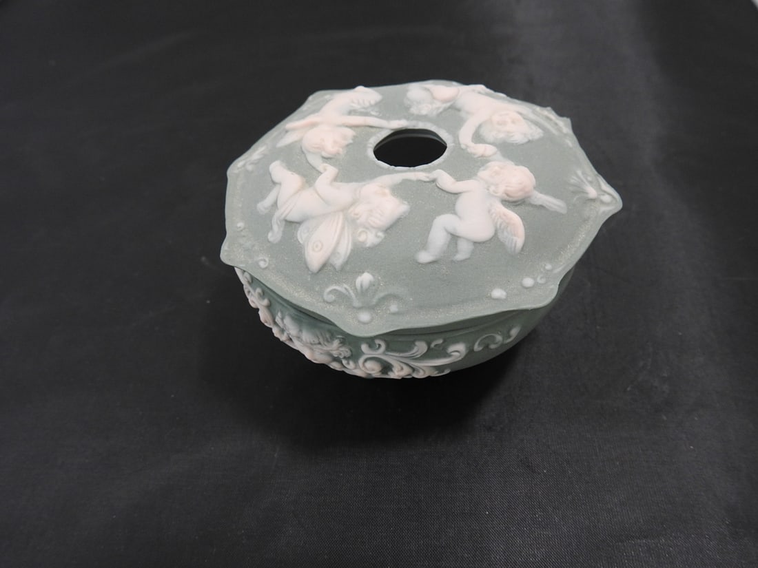 Wedgwood Style Jasperware Porcelain Hair Receiver: Vintage Wedgwood style porcelain hair receiver in pale blue jasperware style with raised white cherub/fairy decoration and floral accents. Manufacturing defect resembling a chip noted inside; see