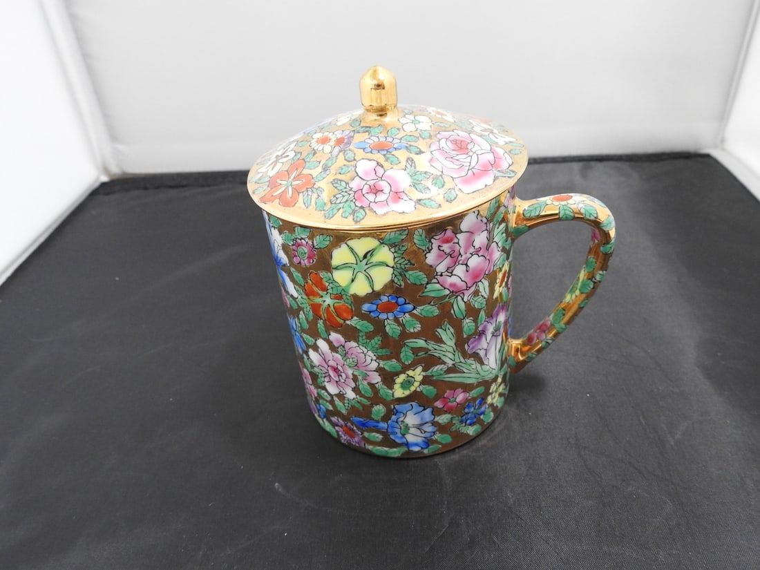 Chinese Rose Famille Style Covered Mug: Chinese rose famille style covered mug with colorful floral and figural decoration, lid, and 24K gold plating per notes. Made in China. Approx. 5 x 4 x 4 in.