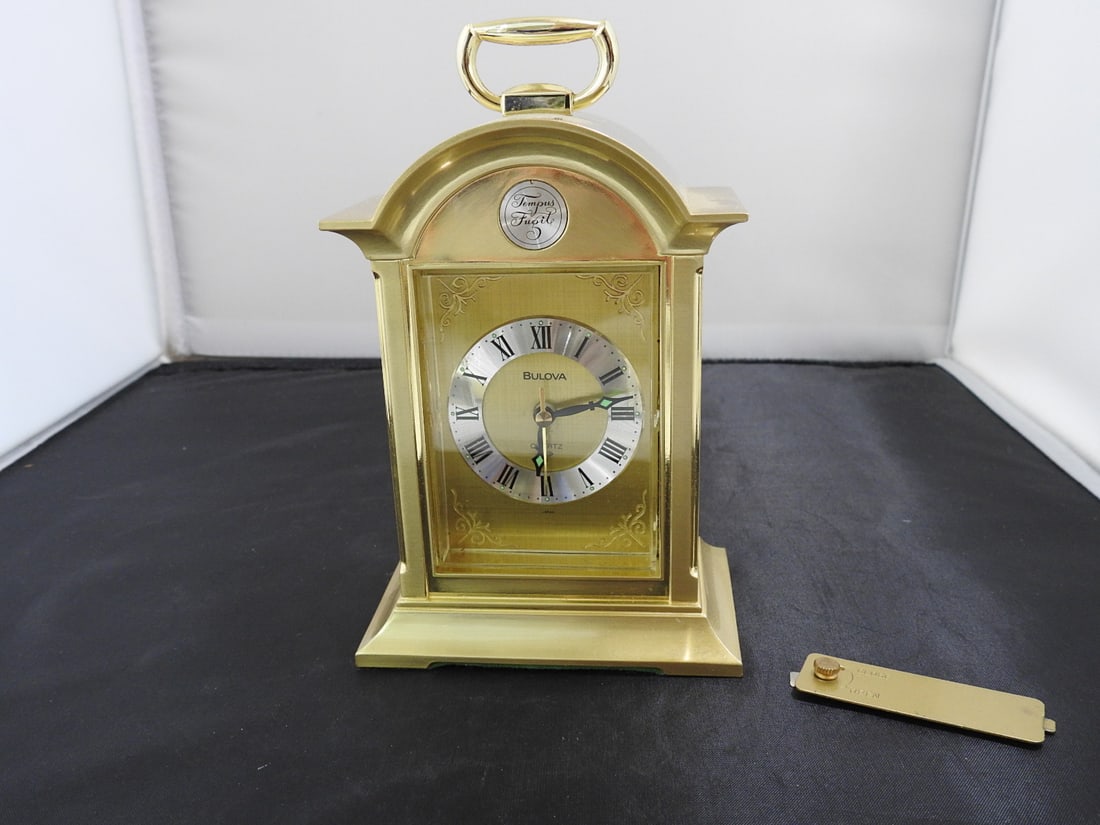 Vintage Bulova Brass Tone Mantel Alarm Clock: Vintage Bulova brass-tone mantel alarm clock with key. Made in Japan; no. 4RE4717. Approx. 6.5 x 4.25 x 3 in.