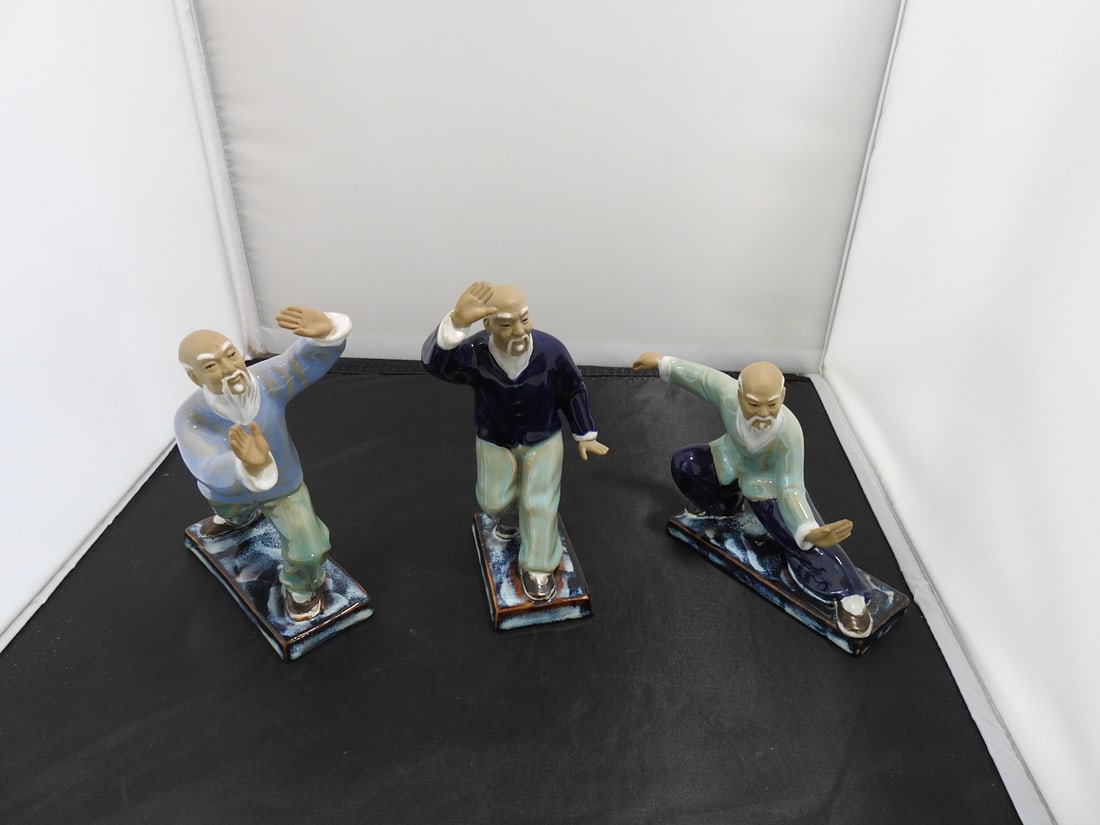 Set of Three Chinese Martial Arts Figurines: Set of three hand-painted, hand-glazed Chinese martial arts figurines marked Wan Jiang / China to undersides. Approx. 6.75 x 6.5 x 6.75 in.