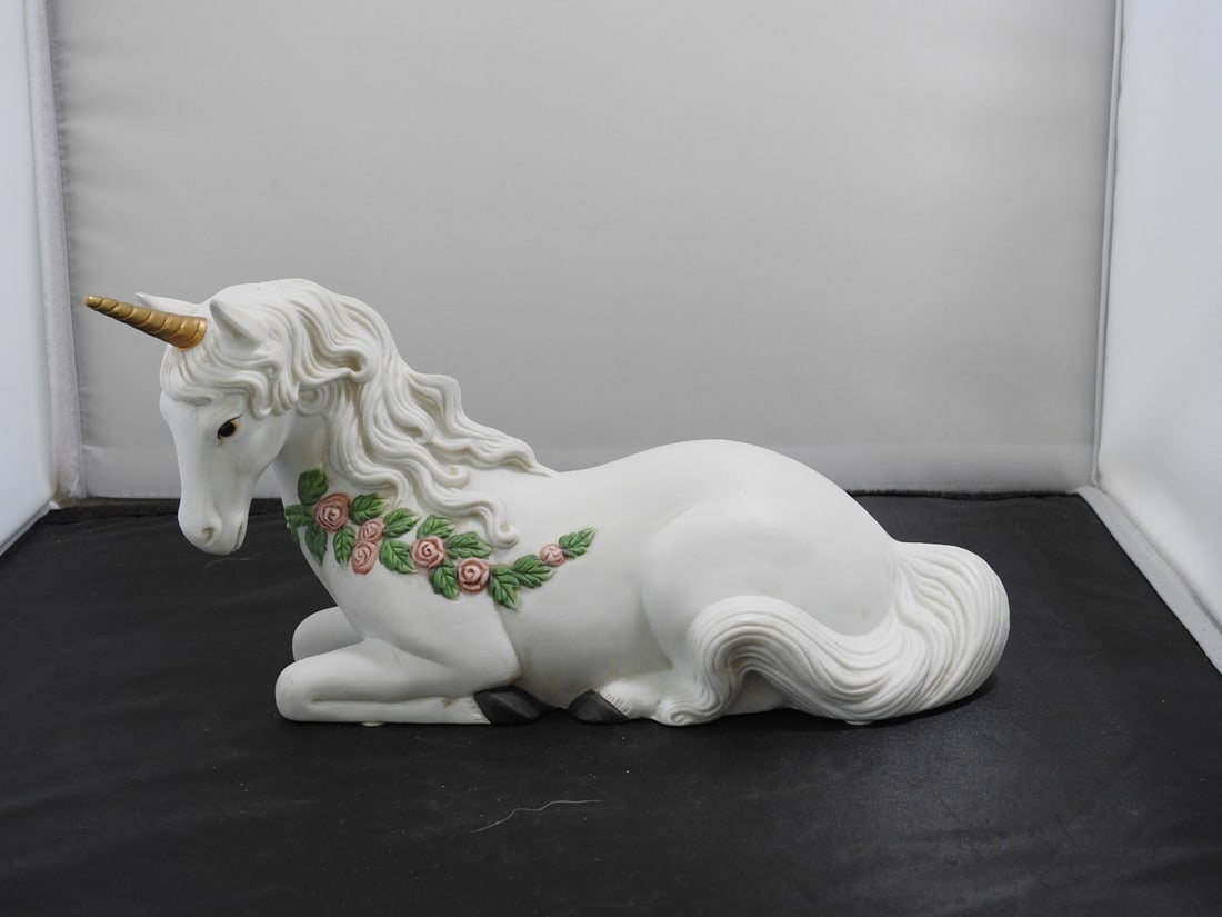 Enesco Porcelain Unicorn Figure: Vintage Enesco porcelain unicorn figure with white body, floral decoration, and gold-colored horn. Bisque finish. Approx. 5.5 x 10.5 x 4.75 in.