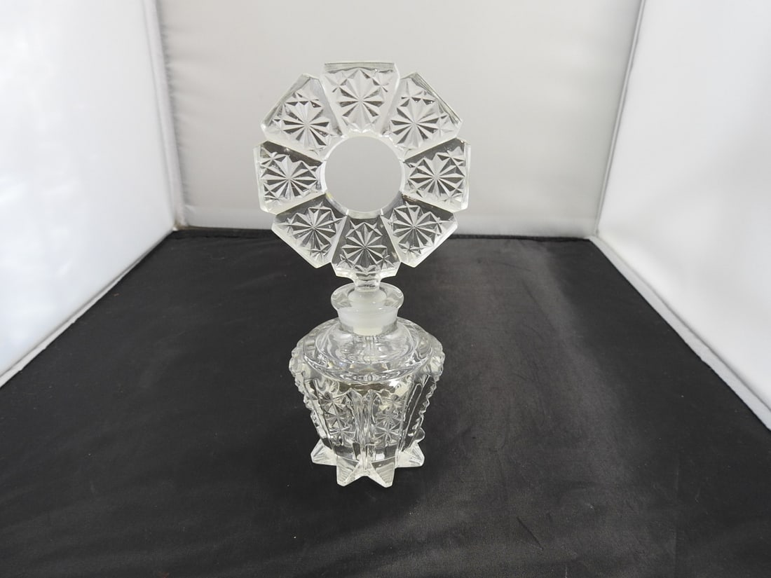 Pressed Glass Perfume Bottle: Pressed glass perfume bottle with stopper and faceted body. Approx. 7.5 x 3.75 x 3.25 in.