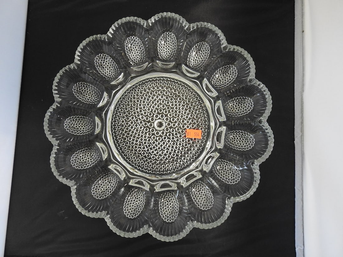 Pressed Glass Deviled Egg Tray: Pressed glass deviled egg tray with hobnail style texture and scalloped floral form. Approx. 2.75 x 11.75 x 11.75 in.