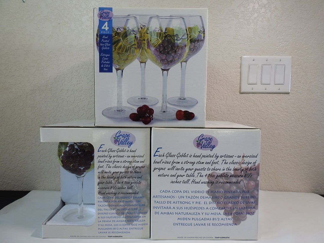 Lot of Three Boxed Fairfield Hand-Painted Wine Glass Sets: Lot of three boxed sets of four Fairfield hand-painted grape motif wine glasses, new in box. Measured as a group. Approx. 21 x 21 x 12 in.