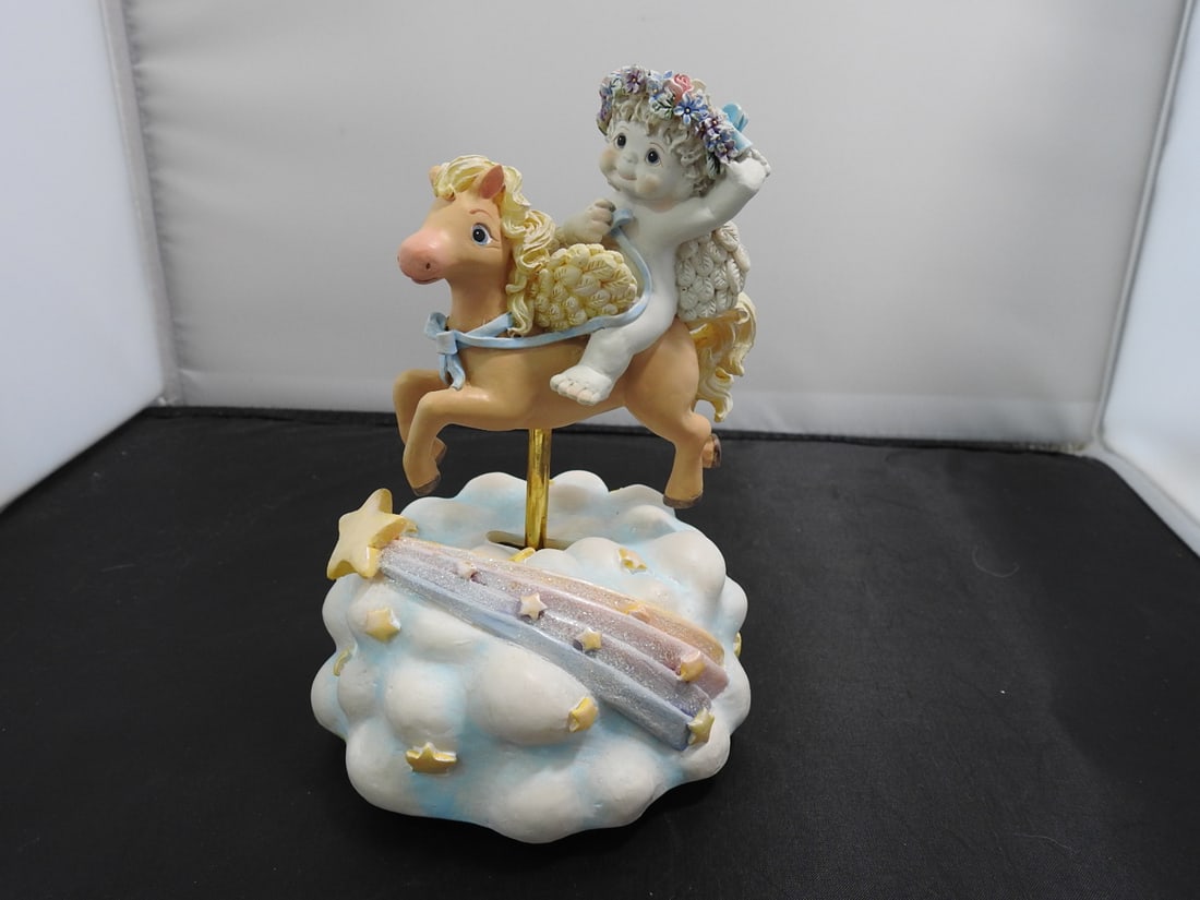 Carousel in the Clouds Musical Figurine: Carousel in the Clouds musical figurine made in China, hand-painted resin with metal pole. Plays music and carousel figure moves. Approx. 6.75 x 4.75 x 4.75 in.
