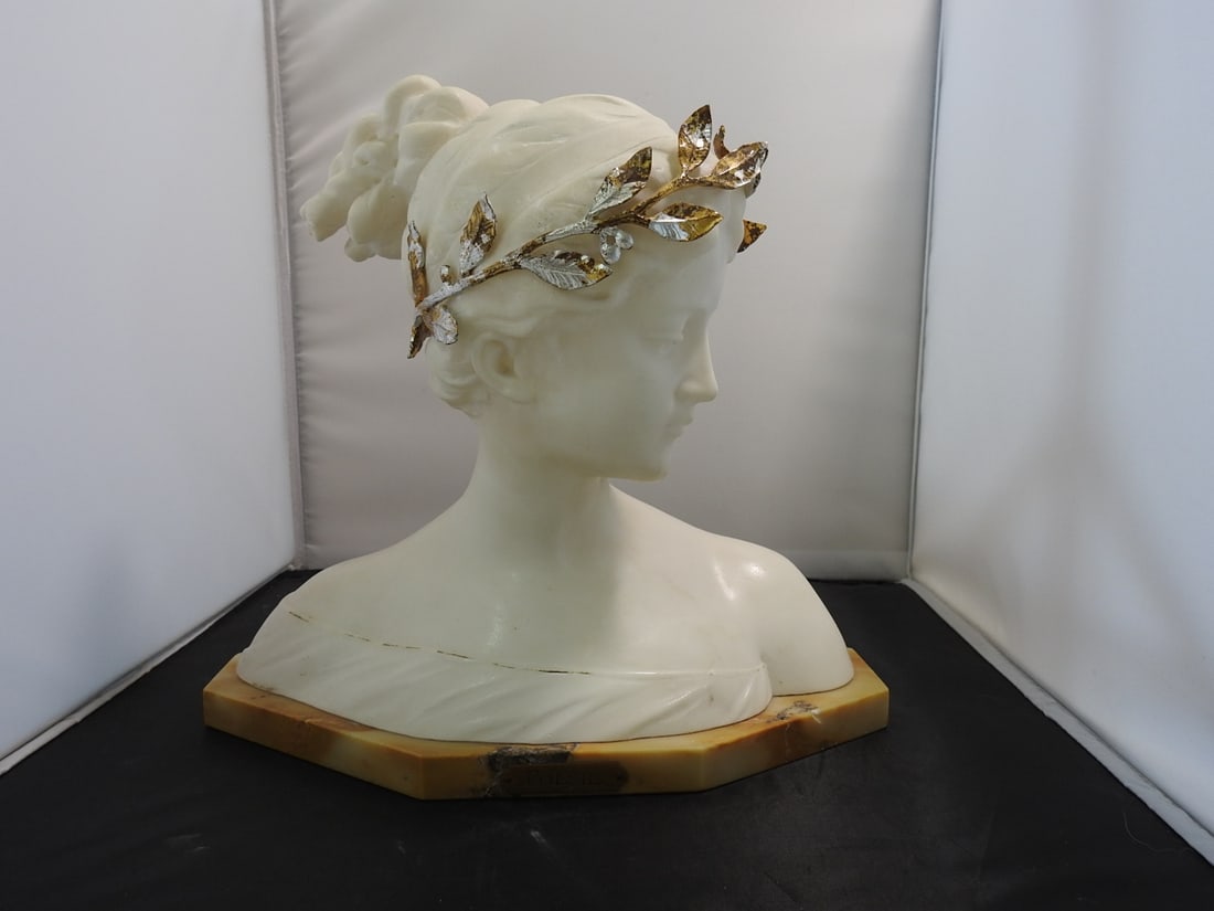 Poesie Marble Bust with Gilt Metal Wreath: Poesie decorative bust in white marble with brown marble base, signed Prof. Garella, with gold gilt metal wreath detail. Remake / decorative reproduction. Approx. 11 x 11.5 x 6.75 in.