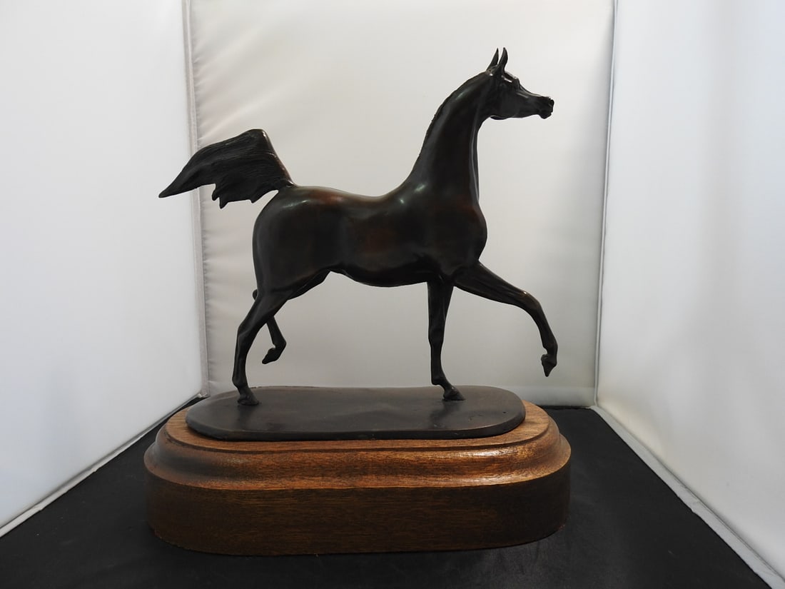 Jill M. Kinney Bronze Horse Statue on Wood Base: Bronze horse statue by Jill M. Kinney, mounted on a raised wooden base. Approx. 11.5 x 11.25 x 6.5 in.