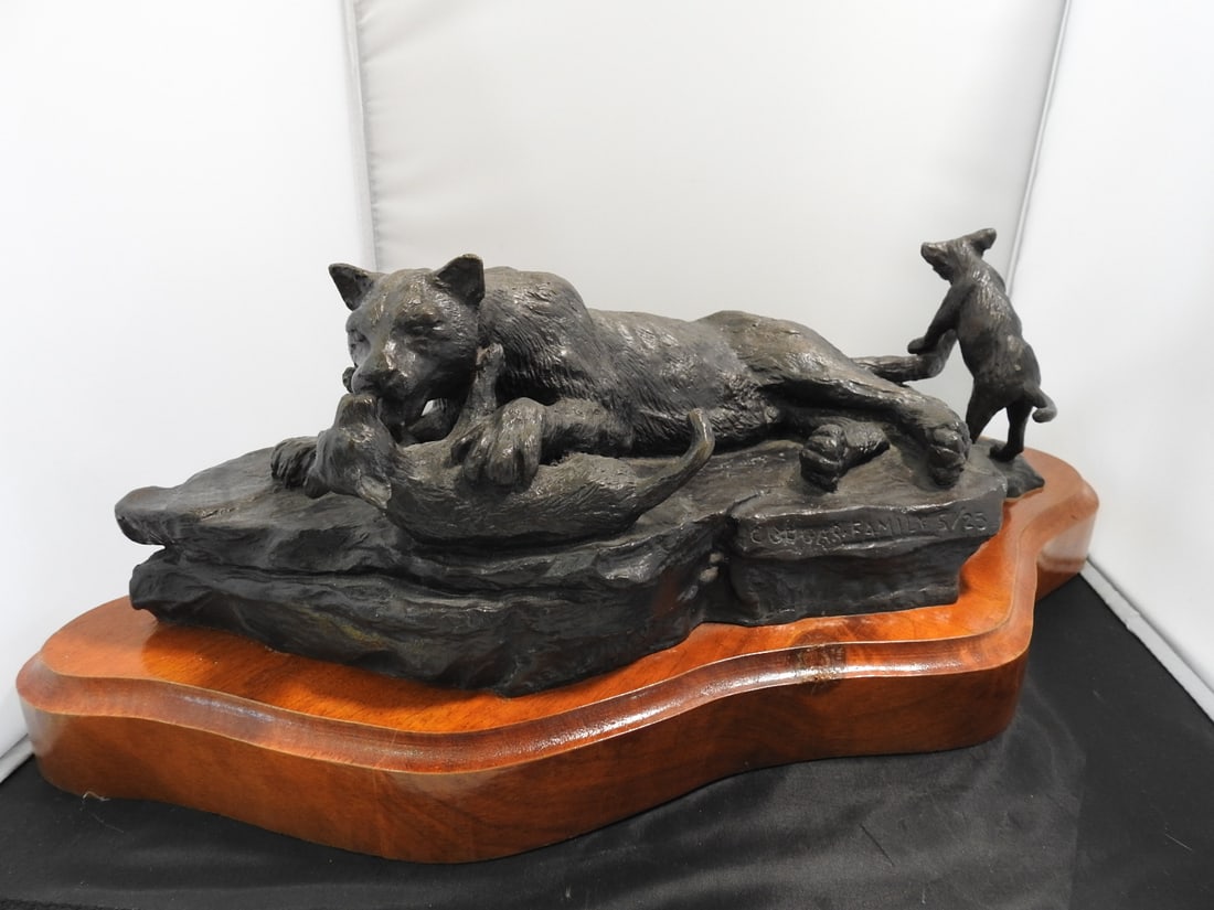 Limited Edition Cougar Family Bronze Sculpture on Wood Base: Cougar Family bronze statue mounted on a wooden base, signed McMCorin and numbered 5/25. Approx. 7 x 19.5 x 12 in.
