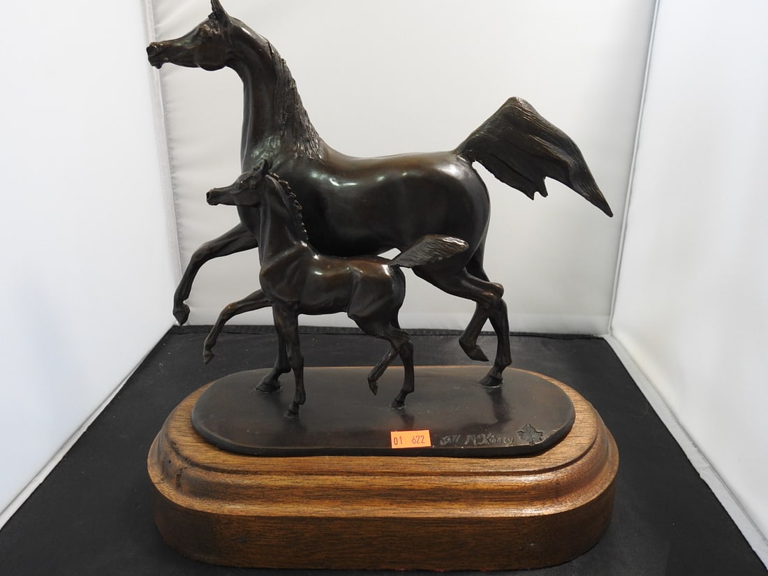 Jill M. Kinney Bronze Mare and Foal Statue on Wood Base: Bronze horse and young horse / mare and foal statue by Jill M. Kinney, mounted on a raised wooden base. Approx. 11 x 11 x 6 in.