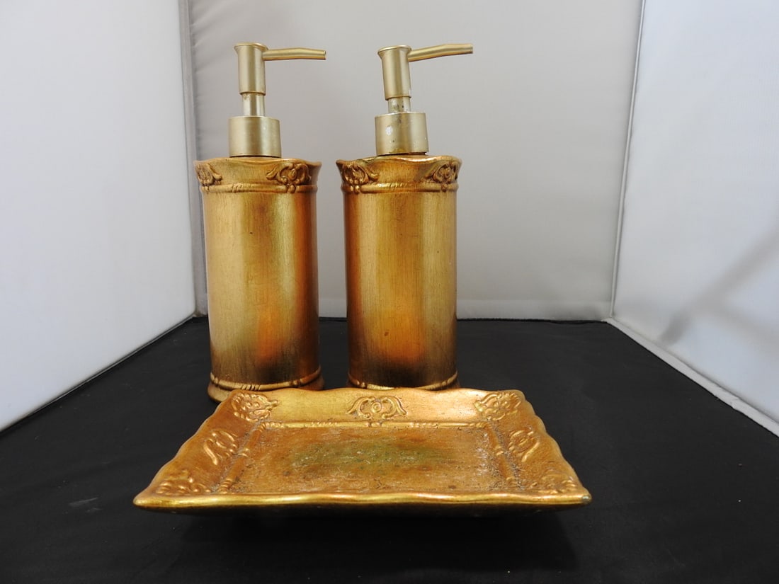 Classic Gold Porcelain Bathroom Set of 3: Classic gold porcelain bathroom set of three pieces with gold leaf style finish. Soap dispenser has a chip and signs of repair. Approx. 8.5 x 6.5 x 7.5 in.