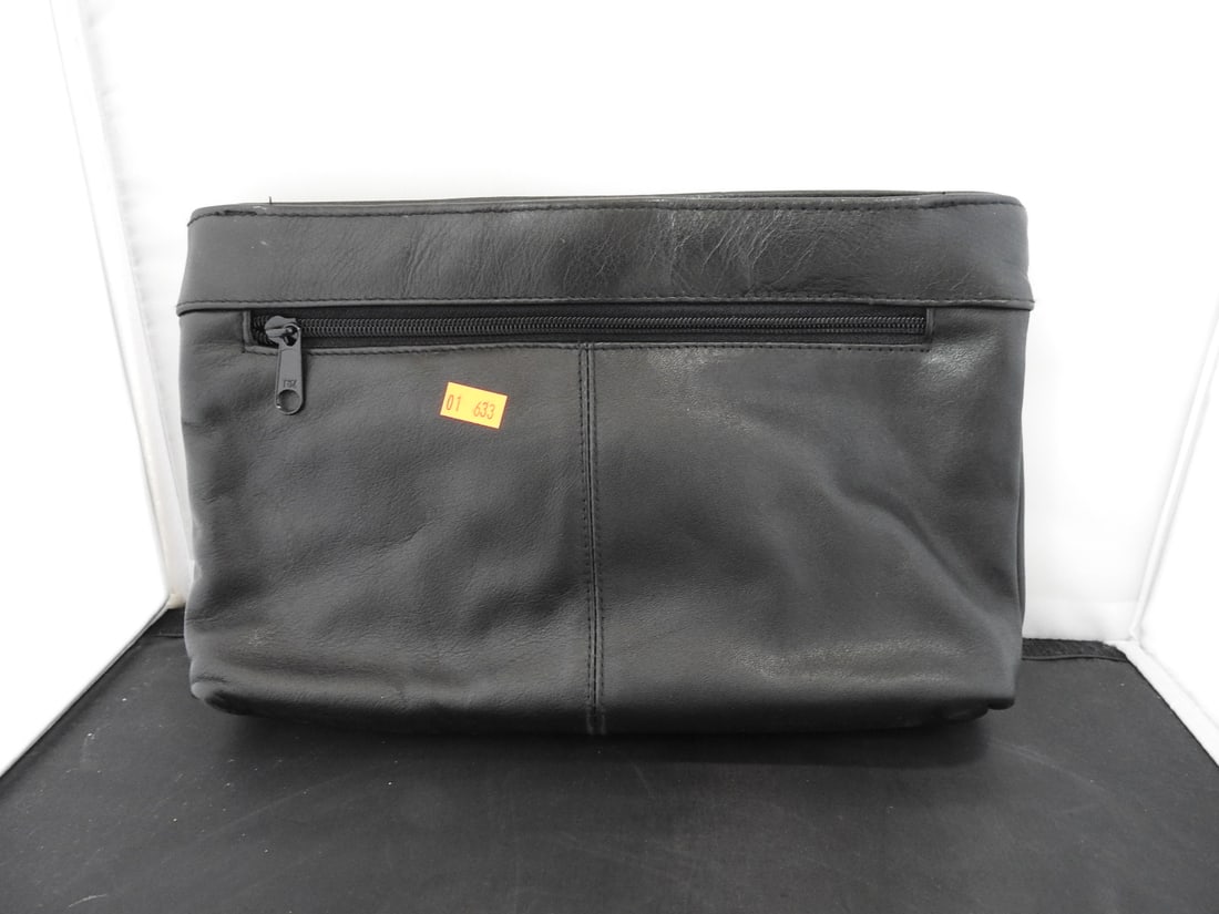 Black First Edition Faux Leather Handbag: Black First Edition faux leather handbag with flap-style front and shoulder strap. Approx. 7.5 x 11.5 x 2.5 in.