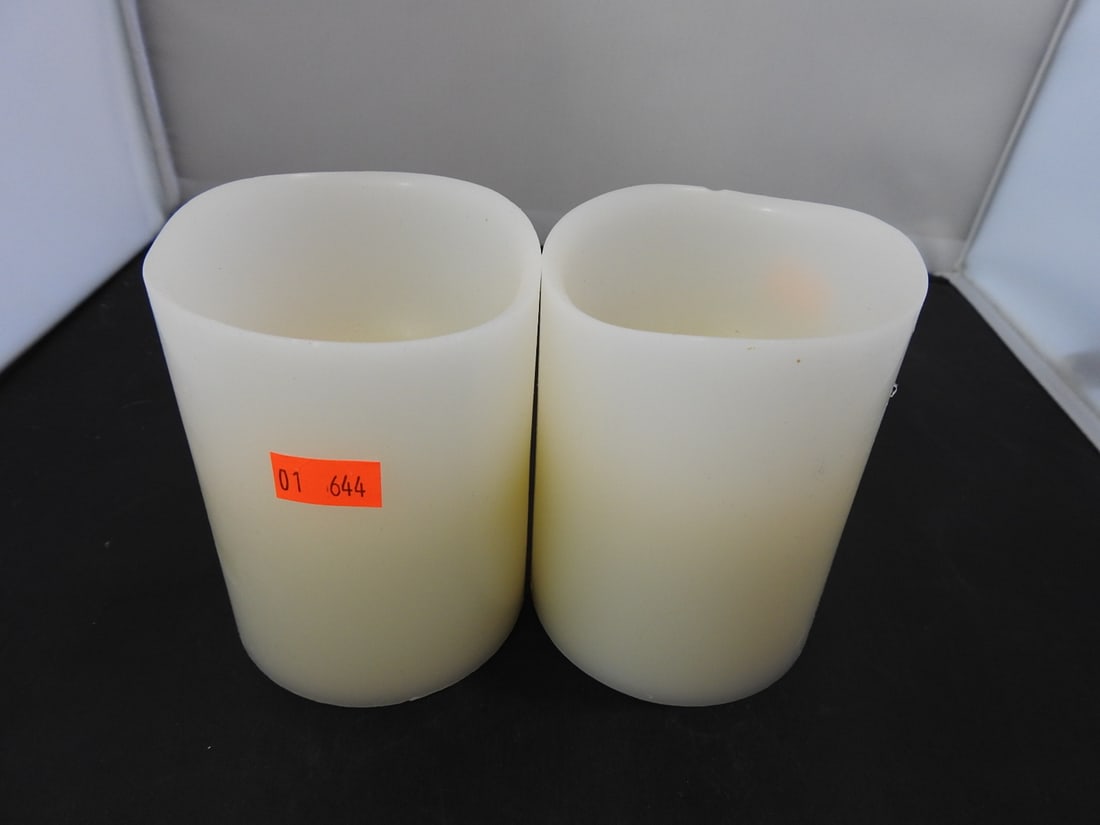 Set of 2 Battery-Operated Pillar Candles: Set of two battery-operated pillar candles with ivory finish. Approx. 4.5 x 6.5 x 3.5 in.