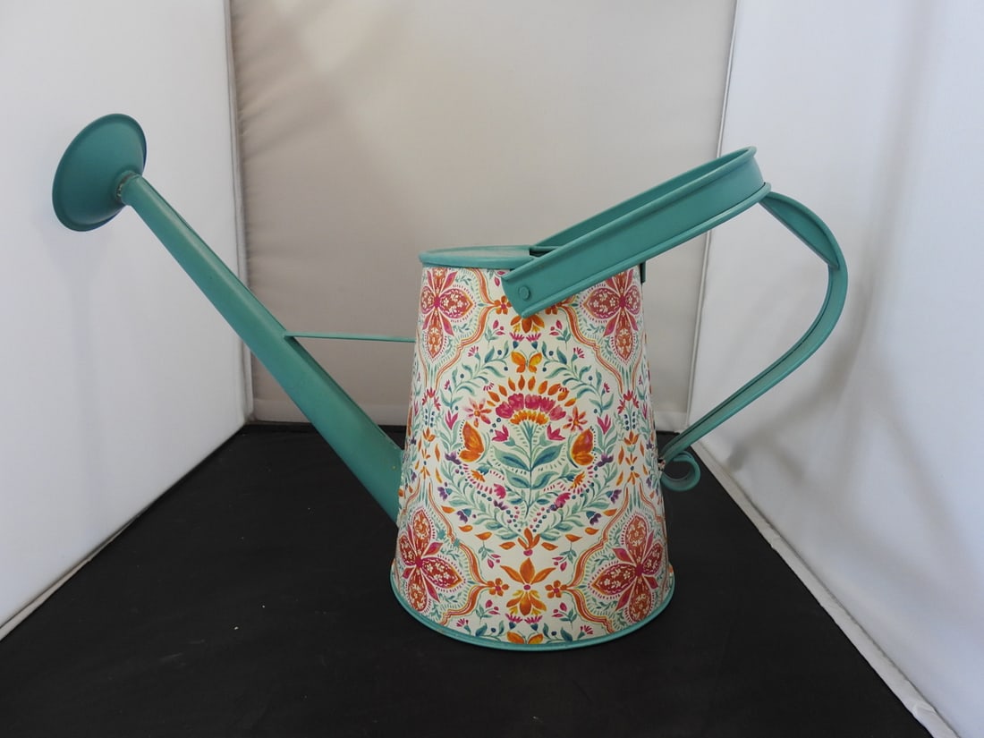 The Pioneer Woman Whimsical Painted Tin Watering Can: Whimsical painted tin watering can by The Pioneer Woman, featuring colorful floral and decorative patterning. Approx. 12 x 16 x 6.5 in.